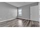 A cozy bedroom features gray walls, wood flooring, and a window for natural light at 7255 W Sunset Rd # 2007, Las Vegas, NV 89113