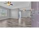 Spacious living room featuring modern gray walls, updated ceiling fans, and stylish wood-look flooring at 7255 W Sunset Rd # 2007, Las Vegas, NV 89113