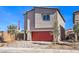 Modern two-story home boasts a red garage door, desert landscaping, and concrete driveway at 804 Ruby Sedona Ave # Lot 152, North Las Vegas, NV 89081