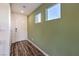 Hallway with wood floors, a green accent wall and a white front door with sidelight windows at 804 Ruby Sedona Ave # Lot 152, North Las Vegas, NV 89081