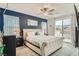 Cozy bedroom offering a dark blue accent wall, comfortable bed, and sliding glass door at 8125 Skye Vineyard Dr, Las Vegas, NV 89166