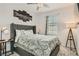 Relaxing bedroom showcasing a large bed with decorative pillows and a stylish city skyline artwork at 8125 Skye Vineyard Dr, Las Vegas, NV 89166