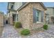 Charming two-story home featuring a stone facade, paved walkway, and manicured landscaping at 8125 Skye Vineyard Dr, Las Vegas, NV 89166