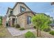 Charming two-story home featuring a stone facade, manicured landscaping, and a welcoming walkway at 8125 Skye Vineyard Dr, Las Vegas, NV 89166