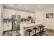 Bright kitchen featuring white cabinets, stainless steel appliances, granite countertops, and bar seating at 8125 Skye Vineyard Dr, Las Vegas, NV 89166