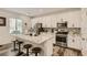 Modern kitchen with white cabinetry, stainless steel appliances, granite countertops, and a breakfast bar at 8125 Skye Vineyard Dr, Las Vegas, NV 89166