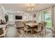 Spacious living room with a large table, chairs, and a view of the backyard through sliding glass doors at 8125 Skye Vineyard Dr, Las Vegas, NV 89166