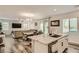 Open-concept living room with hardwood floors and a kitchen island with granite countertops at 8125 Skye Vineyard Dr, Las Vegas, NV 89166