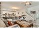 Inviting living room flowing into the kitchen with a large couch and staircase visible at 8125 Skye Vineyard Dr, Las Vegas, NV 89166