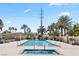 Community pool with tiled deck, lush palms, and clear blue water for relaxing swims and poolside enjoyment at 8255 Las Vegas Blvd # 610, Las Vegas, NV 89123