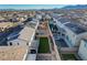 Aerial view of a home with a backyard featuring artificial turf, a dining table, and a pool at 9007 Antora Summit St, Las Vegas, NV 89166