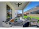 Relaxing covered patio with a ceiling fan and comfortable seating, leading to a well maintained back yard at 9007 Antora Summit St, Las Vegas, NV 89166