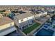 Aerial view of backyard featuring a covered patio, a strip of artificial turf, and a pool at 9007 Antora Summit St, Las Vegas, NV 89166