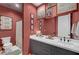 Elegant bathroom featuring double sinks and a shower over the white-tiled floor at 9007 Antora Summit St, Las Vegas, NV 89166