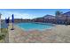 Sparkling community pool area featuring lounge chairs and umbrellas for residents' enjoyment on a sunny day at 9007 Antora Summit St, Las Vegas, NV 89166