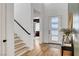 Bright foyer with hardwood floors, staircase, and a modern front door with glass panels at 9007 Antora Summit St, Las Vegas, NV 89166