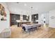 Bright and airy kitchen and dining area featuring gray cabinets, a large island, and seamless flow to the living space at 9007 Antora Summit St, Las Vegas, NV 89166