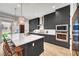 Contemporary kitchen with a center island, pendant lights, and bar stool seating at 9007 Antora Summit St, Las Vegas, NV 89166