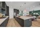 Expansive kitchen featuring gray cabinets, a spacious island, stainless steel appliances, and an open layout at 9007 Antora Summit St, Las Vegas, NV 89166