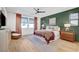 Inviting main bedroom featuring a ceiling fan, hardwood floors, and stylish decor, creating a serene retreat at 9007 Antora Summit St, Las Vegas, NV 89166