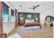 Inviting main bedroom featuring a ceiling fan, hardwood floors, and stylish decor, creating a serene retreat at 9007 Antora Summit St, Las Vegas, NV 89166