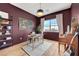 Well-lit home office with a dark accent wall, hardwood floors, and functional decor at 9007 Antora Summit St, Las Vegas, NV 89166