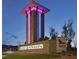 Night view of the Skye Canyon community sign, illuminated with pink and blue lighting at 9007 Antora Summit St, Las Vegas, NV 89166