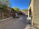 Paved path in backyard leads to steps and water feature, enhancing outdoor living at 945 Pomander Point Pl, Henderson, NV 89012