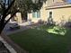 Backyard with artificial turf, fire pit, BBQ, and patio area for relaxation and entertainment at 945 Pomander Point Pl, Henderson, NV 89012