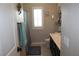 This bathroom features a shower with gray shower curtain and a single sink with a large mirror at 945 Pomander Point Pl, Henderson, NV 89012