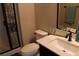 Bathroom featuring stylish fixtures, a modern vanity, a shower with glass doors, and decorative accents at 945 Pomander Point Pl, Henderson, NV 89012