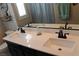 Stylish bathroom featuring double sinks, white countertops, black cabinets, and modern fixtures at 945 Pomander Point Pl, Henderson, NV 89012