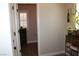 Powder room adjacent to entry way with wood flooring and a decorative cabinet at 945 Pomander Point Pl, Henderson, NV 89012