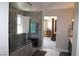 Bathroom featuring a glass shower with a bench and open access to the main bedroom at 945 Pomander Point Pl, Henderson, NV 89012