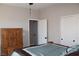 Bright bedroom featuring a wooden armoire, neutral walls, and a closet with classic bi-fold doors at 945 Pomander Point Pl, Henderson, NV 89012