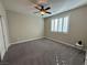 Neutral bedroom featuring a modern ceiling fan, plantation shutters, and plush gray carpeting at 945 Pomander Point Pl, Henderson, NV 89012