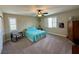 Cozy bedroom with carpet, ceiling fan, plantation shutters, and a comfortable bed with a blue comforter at 945 Pomander Point Pl, Henderson, NV 89012