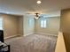 This large bonus room features neutral walls, carpet, ceiling fan, and an abundance of natural light from three windows at 945 Pomander Point Pl, Henderson, NV 89012