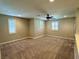 This large bonus room features neutral walls, carpet, ceiling fan, and an abundance of natural light from three windows at 945 Pomander Point Pl, Henderson, NV 89012