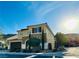 Beautiful two-story stucco home with a well-manicured lawn, dark shutters, and a two-car garage at 945 Pomander Point Pl, Henderson, NV 89012