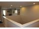 The second floor hallway has carpeted floors and overlooks the downstairs living area from a wall at 945 Pomander Point Pl, Henderson, NV 89012
