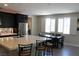 Modern kitchen features a large island, stainless steel appliances, and a dining area bathed in natural light at 945 Pomander Point Pl, Henderson, NV 89012