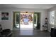 Living room with sliding glass doors that open to a private stone-walled courtyard and water feature at 945 Pomander Point Pl, Henderson, NV 89012