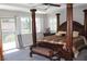 A main bedroom includes a four poster bed, carpet and natural light from windows at 945 Pomander Point Pl, Henderson, NV 89012