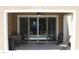 Covered patio featuring sliding glass doors leading to a backyard oasis with multiple seating areas at 945 Pomander Point Pl, Henderson, NV 89012