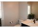 Charming powder room featuring a black vanity, modern sink and window with privacy shutters at 945 Pomander Point Pl, Henderson, NV 89012
