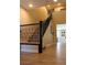 A staircase showcases wood-look floors, black railing and neutral colored walls at 945 Pomander Point Pl, Henderson, NV 89012