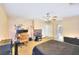 Bedroom featuring two ceiling fans, carpet flooring, and an ensuite bathroom at 9879 Jazzy June St, Las Vegas, NV 89183