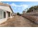 Backyard with desert landscaping and a light-colored single-story home with a tiled roof at 10029 Netherton Dr, Las Vegas, NV 89134