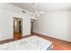 Bright bedroom with a ceiling fan, neutral walls and hardwood floors leading to an en suite bathroom and closet at 10029 Netherton Dr, Las Vegas, NV 89134